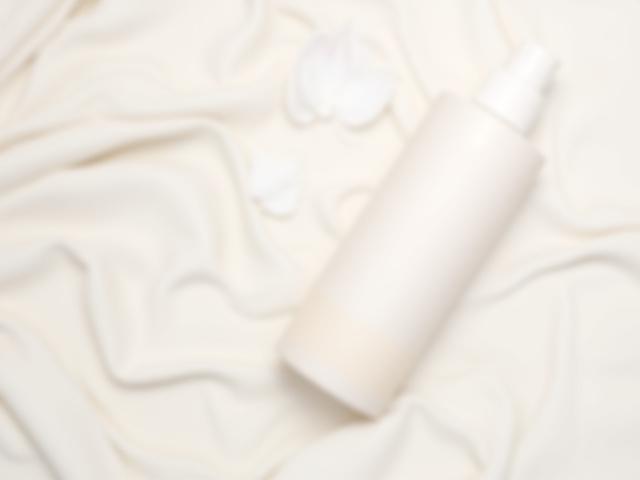 Aesthetic flat lay of Aura Beauty Co. skincare products in minimalist packaging.